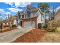 Well-maintained home with brick and gray siding, featuring a two-car garage and a spacious driveway at 3369 Arbor Path Drive Dr, Atlanta, GA 30340