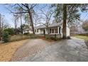 Long driveway leading to the home with brickwork, complemented by mature trees and landscaping at 2508 Brookwood Ne Dr, Atlanta, GA 30305