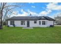 Expansive backyard showcasing well-maintained lawn, mature trees, and rear exterior of the home at 2964 Hollow Ln, Powder Springs, GA 30127