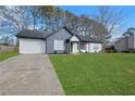 Beautifully landscaped home featuring a well-manicured lawn and welcoming curb appeal at 2964 Hollow Ln, Powder Springs, GA 30127
