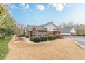 Charming single-story home with manicured landscaping, a well-kept lawn, and brick accents at 4479 Caleb Xing, Powder Springs, GA 30127