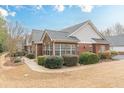 Charming single-story home with manicured landscaping, brick accents, and a stone facade at 4479 Caleb Xing, Powder Springs, GA 30127