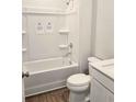 Clean bathroom featuring a shower-tub combo, white fixtures, and wood-look flooring at 2359 Brown Dove Way (Lot 2), Grayson, GA 30017
