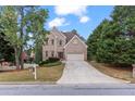 Traditional two-story brick home features an attached two-car garage, mature trees and landscaping at 3113 Brians Creek Se Dr, Conyers, GA 30013