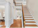 Grand foyer with hardwood floors, staircase, and elegant columns creates a welcoming entrance at 3113 Brians Creek Se Dr, Conyers, GA 30013