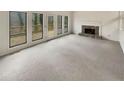 Bright living room with fireplace and sliding glass doors leading to an outdoor balcony at 80 Colony Ridge Dr, Alpharetta, GA 30022