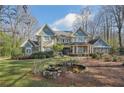 Beautiful home with professionally landscaped front yard, water feature, and attached garage at 9865 Buice Rd, Alpharetta, GA 30022