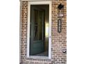 Inviting entryway showcasing front door with sidelights and brick wall with house number at 1055 Dryden Ln # 10, Atlanta, GA 30319