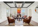 Bright living room with coffered ceiling, hardwood floors, and stylish seating arrangement at 3015 Woodvale Ct, Alpharetta, GA 30022