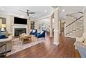 Cozy living room with fireplace, hardwood floors, and an open layout leading to the dining area at 3232 Cates Ne Ave, Brookhaven, GA 30319