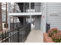 Exterior view of condominium complex featuring gray siding, black railings, and well-lit stairwells at 602 Granville Ct, Sandy Springs, GA 30328