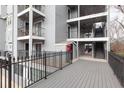 Exterior condominium view featuring multi-story buildings, wrought iron railings and outdoor patio at 602 Granville Ct, Sandy Springs, GA 30328