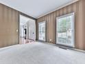 Cozy living room with neutral carpeting and large windows offering natural light at 907 Fox Croft Pl, Canton, GA 30114