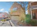 Side view of home showing brick exterior and garage with side street and partial landscaping at 1600 Yukon Ct, Atlanta, GA 30349