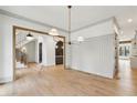 Bright dining room with elegant chandelier and hardwood floors, open to staircase and butler's pantry at 1445 Ashwoody Ne Ct, Atlanta, GA 30319