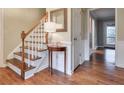 Foyer with hardwood floors, stairs with a white banister, and wainscoting at 1849 Linnet Ne Ct, Roswell, GA 30075