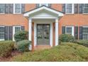 Charming front entrance with brick, symmetrical bushes, and a covered porch at 1849 Linnet Ne Ct, Roswell, GA 30075