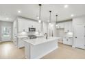 Modern kitchen with white cabinets, quartz countertops, and stainless steel appliances at 5619 Tillman Way, Powder Springs, GA 30127