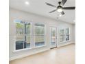 Spacious living room with light hardwood floors, large windows, and ceiling fan at 5619 Tillman Way, Powder Springs, GA 30127