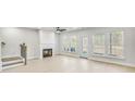 Bright living room with a fireplace, hardwood floors, and natural light at 5619 Tillman Way, Powder Springs, GA 30127