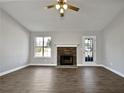 Bright living room featuring a stone fireplace and neutral decor at 99 Cedars Glen Way, Villa Rica, GA 30180