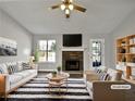 Bright living room featuring a stone fireplace and neutral decor at 99 Cedars Glen Way, Villa Rica, GA 30180