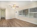 Sun-filled living room featuring a modern ceiling fan, laminate flooring, and large window at 1146 Canal St, Decatur, GA 30032
