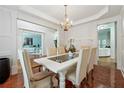 Elegant dining room with hardwood floors, chandelier lighting, and views into the living areas at 1412 Great Shoals Dr, Lawrenceville, GA 30045
