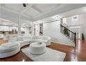 Bright living room showcasing hardwood floors, coffered ceilings, and a staircase with iron railings at 1412 Great Shoals Dr, Lawrenceville, GA 30045