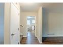 Hallway with wood floors leading to a kitchen featuring white cabinets at 2202 Troutdale Dr, Decatur, GA 30032
