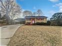 Charming two-story home with red shutters, white door, and attached carport at 6742 Green Meadows Ln, Morrow, GA 30260