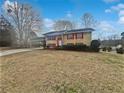 Charming two-story home with red shutters, white door, and attached carport at 6742 Green Meadows Ln, Morrow, GA 30260
