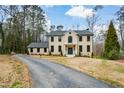 Elegant front exterior view of a two-story home with a well-manicured lawn and a long driveway at 805 Wesley Oak Rd, Atlanta, GA 30328