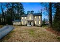 Front exterior view of a two-story home with a well-manicured lawn, taken at twilight at 805 Wesley Oak Rd, Atlanta, GA 30328