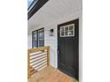 Close up view of a black front door with sidelight, showcasing the home's curb appeal at 3393 Phillip Cir, Decatur, GA 30032