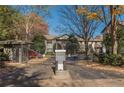 Gated community entrance with brick paved road surrounded by mature trees at 44 Finch Ne Trl, Atlanta, GA 30308