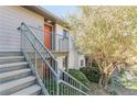 Inviting condo entrance featuring stairs leading to a vibrant orange front door at 44 Finch Ne Trl, Atlanta, GA 30308