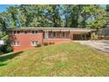 Charming brick ranch home with a carport and well-maintained lawn at 2837 Davidson Dr, Lithonia, GA 30058
