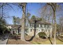 Charming two-story home featuring stone accents, lush landscaping, and a welcoming front entrance at 1742 Dunridge Ct, Dunwoody, GA 30338
