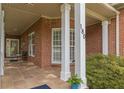 Inviting front porch with tiled flooring, white columns, and view of the front door at 180 Winecoff Dr, Fayetteville, GA 30214