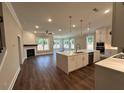 Open-concept kitchen and living room with a large island, fireplace, and lots of natural light at 184 Vinca Nw Cir, Kennesaw, GA 30144