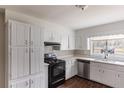 Functional kitchen showcasing white cabinets, an oven range, stainless steel dishwasher, and natural light at 1561 Rupert Rd, Decatur, GA 30032