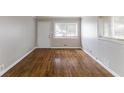 Bright living room with hardwood floors, a large window with natural light, and neutral paint at 1561 Rupert Rd, Decatur, GA 30032