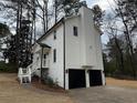 View of the rear of the home showcasing a two-car garage at 3663 Heatherwood Ne Dr, Marietta, GA 30066