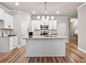Modern kitchen with white cabinetry, granite countertops, and stainless steel appliances at 253 Beau St, Lilburn, GA 30047