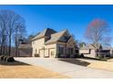 Exterior side view featuring a long driveway and basketball hoop at 4095 Copper Leaf Ln, Cumming, GA 30040