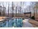 A luxury pool and backyard area for entertaining at 4095 Copper Leaf Ln, Cumming, GA 30040