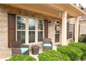 Welcoming front porch with comfortable seating area and decorative accents, framed by lush greenery at 2600 Reece Farms Sw Trl, Powder Springs, GA 30127