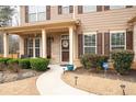 Inviting front porch with brick accents, a decorative wreath, and well-maintained landscaping at 2600 Reece Farms Sw Trl, Powder Springs, GA 30127
