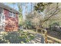 View of the side yard with a walkway and wooden railing leading to the backyard at 3073 Henderson Mill Rd, Atlanta, GA 30341